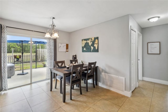 dining room featuring light tile patterned flooring, baseboards, and a chandelier