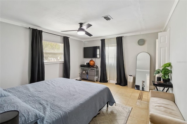 bedroom with ornamental molding, light tile patterned floors, and ceiling fan