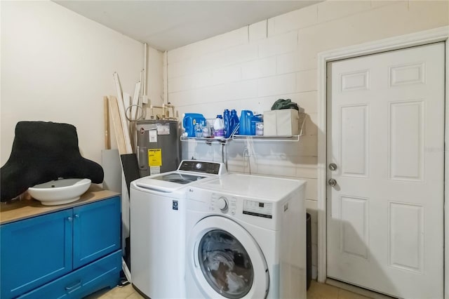 clothes washing area with water heater, washing machine and clothes dryer, and cabinet space