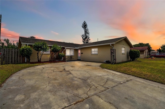 ranch-style home featuring driveway