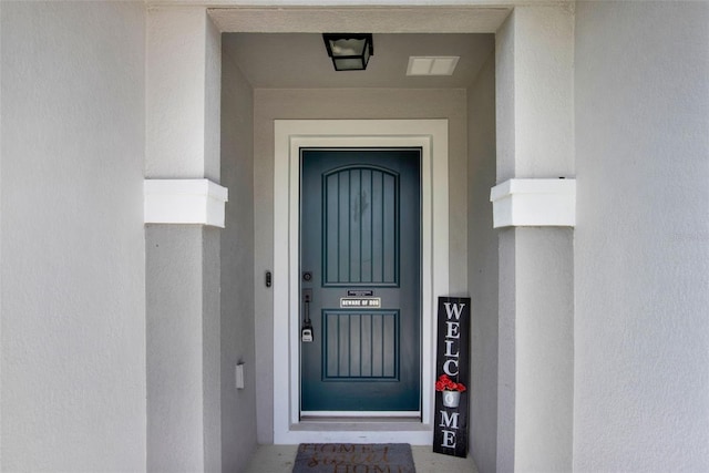 208 Summerlin Ln, Haines City, FL 33844 - doorway to property featuring stucco siding