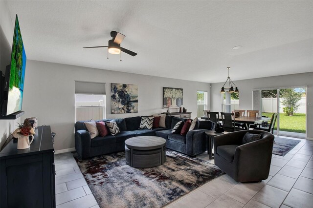 208 Summerlin Ln, Haines City, FL 33844 - tiled living room featuring ceiling fan and baseboards