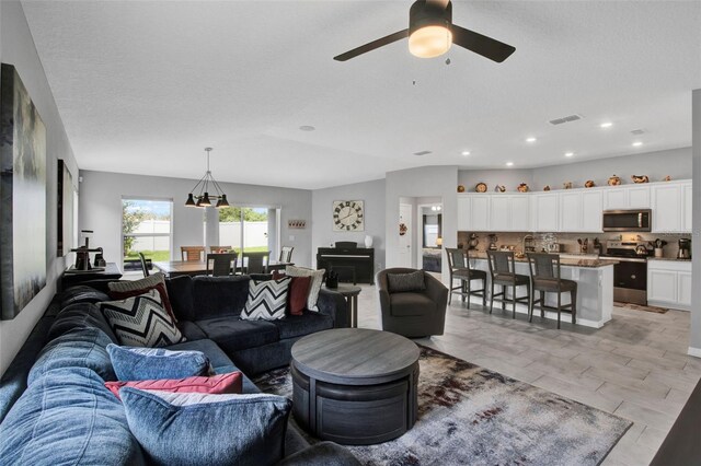 208 Summerlin Ln, Haines City, FL 33844 - living room with a ceiling fan, recessed lighting, and a chandelier