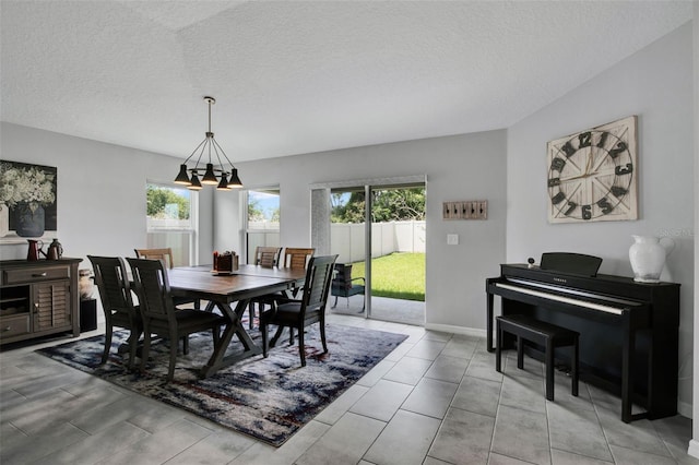 208 Summerlin Ln, Haines City, FL 33844 - dining space featuring a textured ceiling and a chandelier