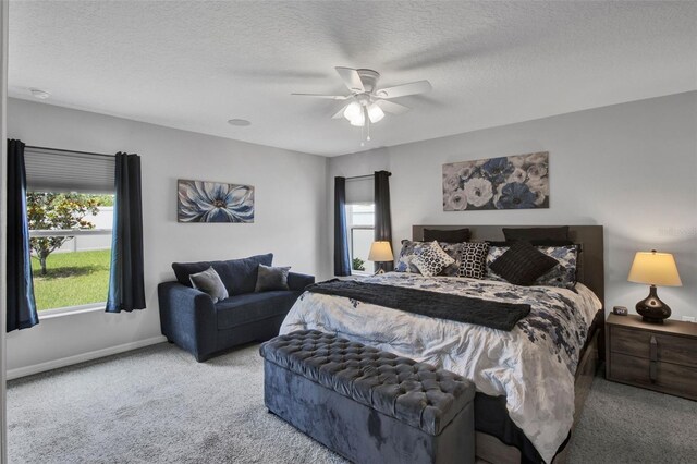 208 Summerlin Ln, Haines City, FL 33844 - bedroom featuring carpet floors, a textured ceiling, ceiling fan, and baseboards