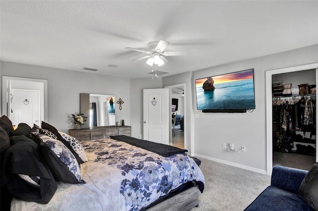 208 Summerlin Ln, Haines City, FL 33844 - carpeted bedroom featuring baseboards, a walk in closet, ceiling fan, and a closet