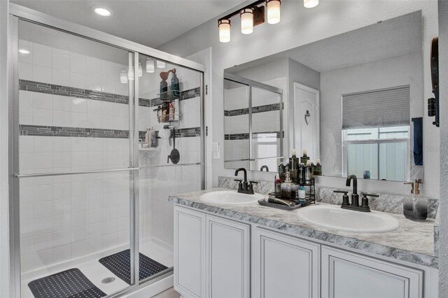 208 Summerlin Ln, Haines City, FL 33844 - bathroom with a stall shower and double vanity