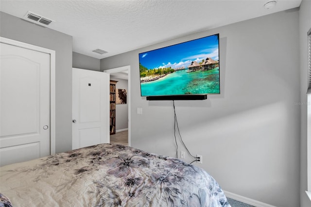 208 Summerlin Ln, Haines City, FL 33844 - bedroom with carpet, baseboards, and a textured ceiling