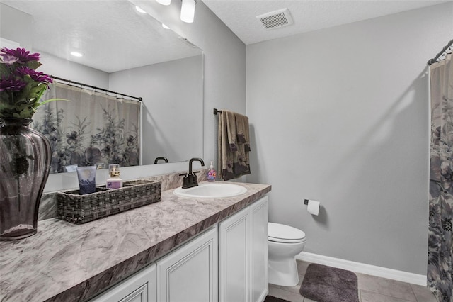 208 Summerlin Ln, Haines City, FL 33844 - bathroom with vanity, toilet, tile patterned floors, baseboards, and a textured ceiling