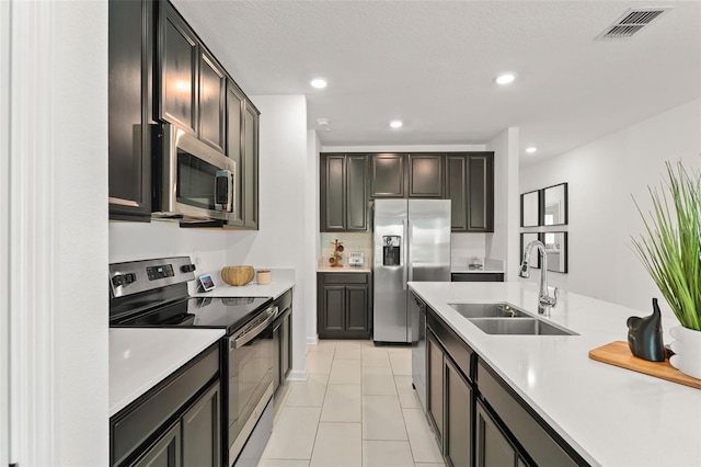 6834 Wilson Hammock Ave, Groveland, FL 34736 - kitchen with appliances with stainless steel finishes, a sink, light countertops, recessed lighting, and light tile patterned flooring