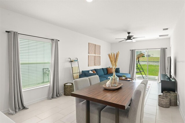 6834 Wilson Hammock Ave, Groveland, FL 34736 - dining room featuring a ceiling fan, light tile patterned floors, and baseboards