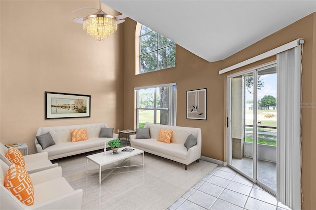 2498 Saint Augustine Blvd, Haines City, FL 33844 - living room with light tile patterned flooring, a chandelier, baseboards, and a towering ceiling