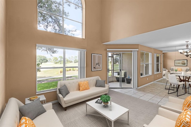2498 Saint Augustine Blvd, Haines City, FL 33844 - living room with a chandelier, plenty of natural light, a high ceiling, light tile patterned floors, and baseboards