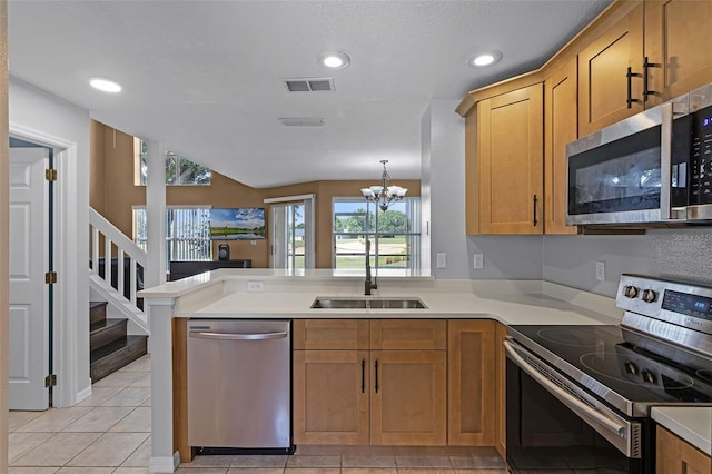 2498 Saint Augustine Blvd, Haines City, FL 33844 - kitchen featuring appliances with stainless steel finishes, a sink, a peninsula, light countertops, and recessed lighting