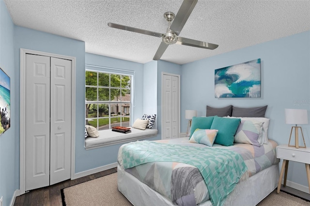 2498 Saint Augustine Blvd, Haines City, FL 33844 - bedroom featuring two closets, a textured ceiling, wood finished floors, a ceiling fan, and baseboards