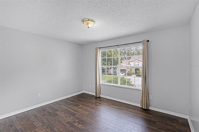 2498 Saint Augustine Blvd, Haines City, FL 33844 - empty room with dark wood finished floors, a textured ceiling, and baseboards