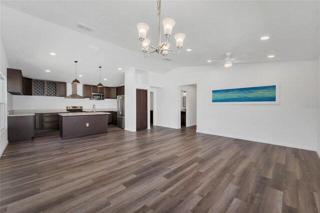 1040 20th St, Orlando, FL 32805 - kitchen with open floor plan, stainless steel appliances, dark brown cabinets, lofted ceiling, and recessed lighting