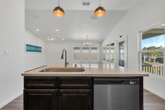 1040 20th St, Orlando, FL 32805 - kitchen with stainless steel dishwasher, a sink, lofted ceiling, dark wood finished floors, and light countertops