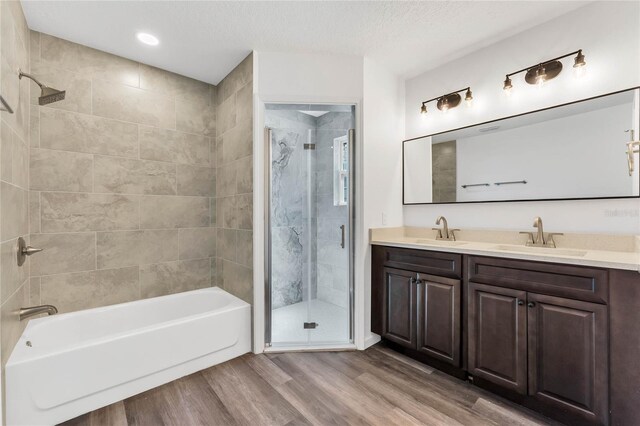 1040 20th St, Orlando, FL 32805 - bathroom featuring wood finished floors, double vanity, a textured ceiling, and recessed lighting