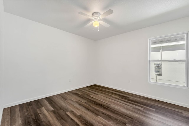 1040 20th St, Orlando, FL 32805 - spare room with dark wood-style floors, a ceiling fan, and baseboards
