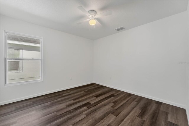 1040 20th St, Orlando, FL 32805 - empty room featuring dark wood-style floors, ceiling fan, and baseboards