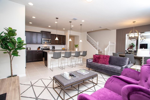 8944 Sydney Ave, Kissimmee, FL 34747 - living room featuring light tile patterned floors, a chandelier, recessed lighting, and stairs