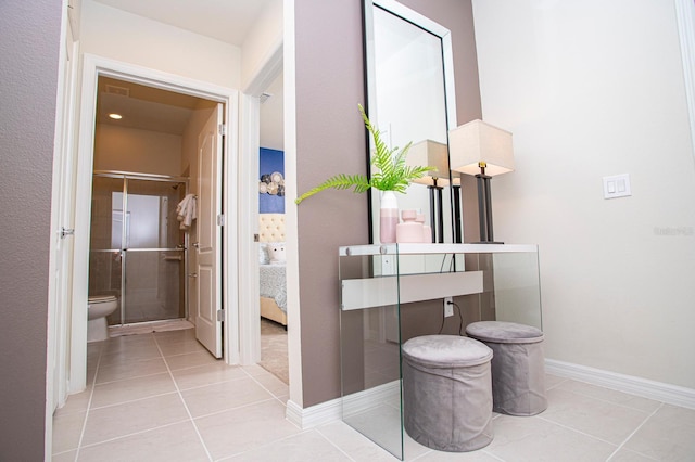 8944 Sydney Ave, Kissimmee, FL 34747 - bathroom with tile patterned flooring, toilet, a shower stall, ensuite bathroom, and baseboards
