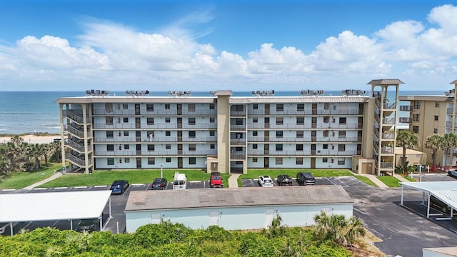 3180 Ocean Shore Blvd Unit 407, Ormond Beach, FL 32176 - view of apartment building / complex featuring uncovered parking and a water view