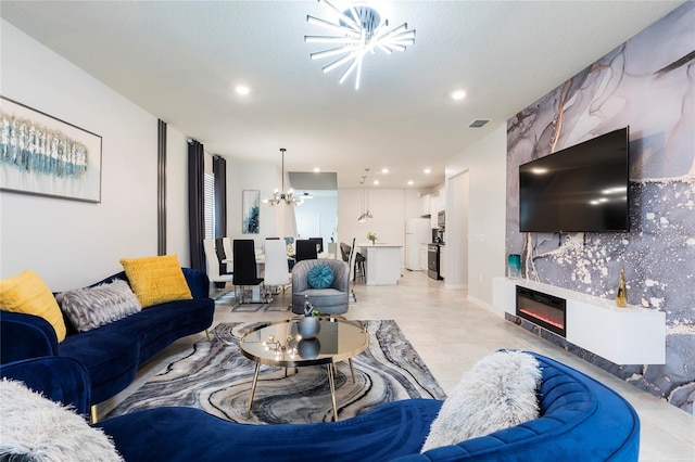living area with a chandelier, recessed lighting, and a fireplace
