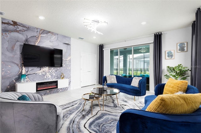 living area with a glass covered fireplace and recessed lighting