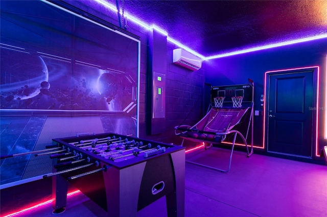 rec room with an AC wall unit and concrete block wall