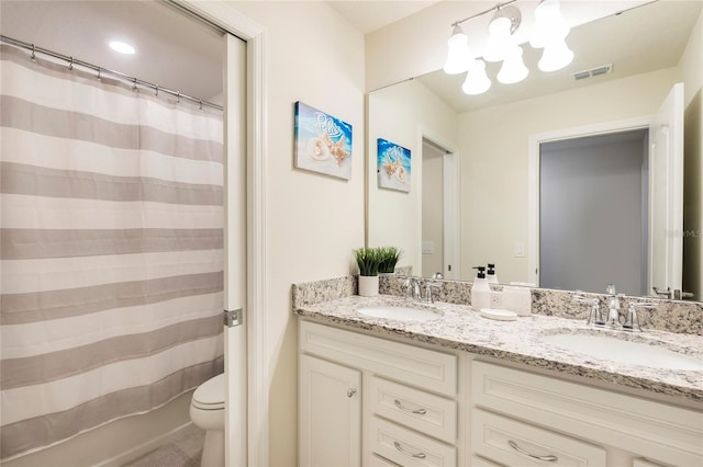 full bathroom featuring toilet, double vanity, curtained shower, and a chandelier