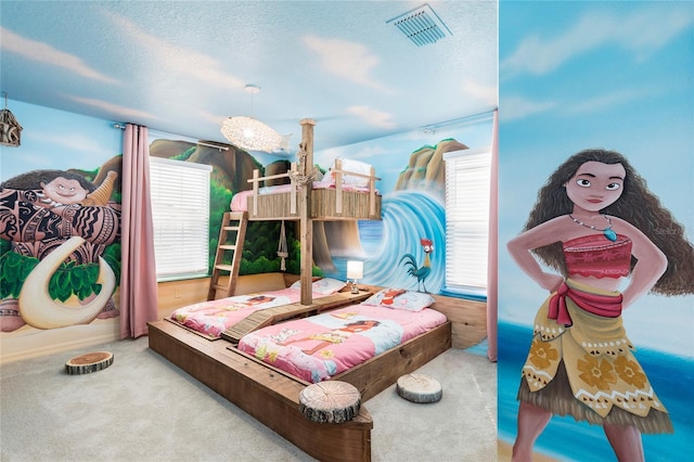 bedroom featuring multiple windows, carpet, and a textured ceiling