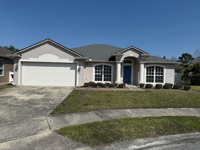 ranch-style house with an attached garage, driveway, a front lawn, and stucco siding