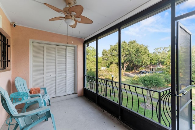 sunroom / solarium with a ceiling fan and healthy amount of natural light