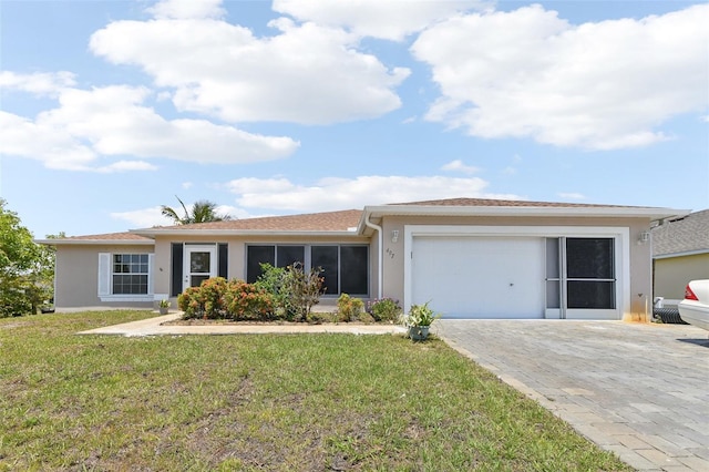 497 Lafayette St SW, Palm Bay, FL 32908 - single story home with stucco siding, a garage, a front lawn, and decorative driveway