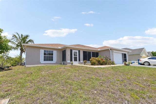 497 Lafayette St SW, Palm Bay, FL 32908 - view of front facade featuring an attached garage, stucco siding, a front yard, and central AC