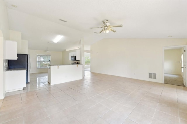 497 Lafayette St SW, Palm Bay, FL 32908 - unfurnished living room featuring light tile patterned floors, healthy amount of natural light, ceiling fan, and vaulted ceiling