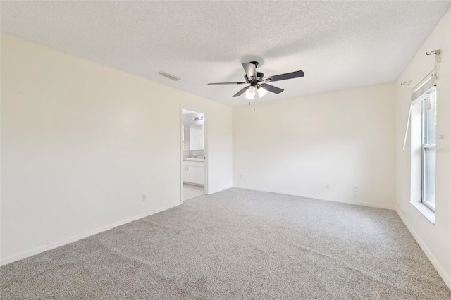 497 Lafayette St SW, Palm Bay, FL 32908 - spare room featuring light carpet, a ceiling fan, a textured ceiling, and baseboards