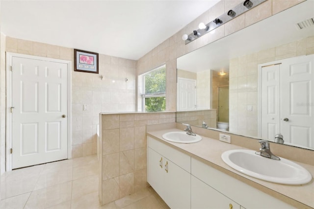 497 Lafayette St SW, Palm Bay, FL 32908 - bathroom featuring tile walls, a tile shower, tile patterned floors, and double vanity