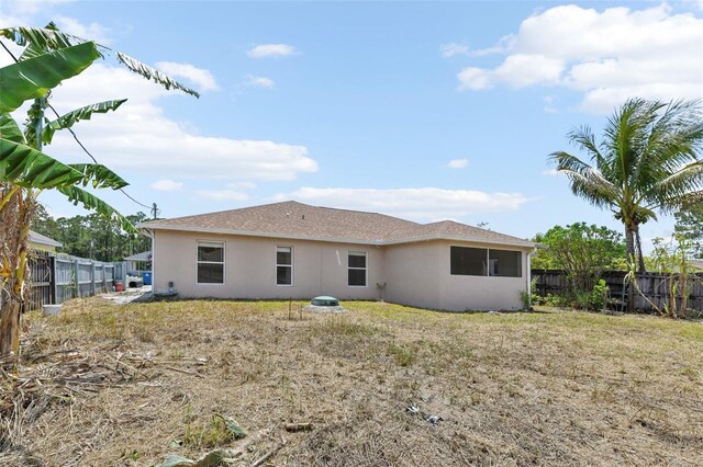 497 Lafayette St SW, Palm Bay, FL 32908 - rear view of house featuring stucco siding and a fenced backyard