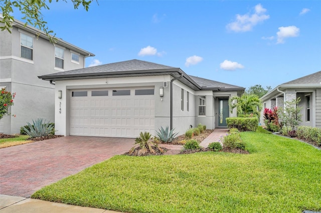 3149 Songbird Cir, Harmony, FL 34773 - view of front of property with decorative driveway, stucco siding, an attached garage, and a front yard
