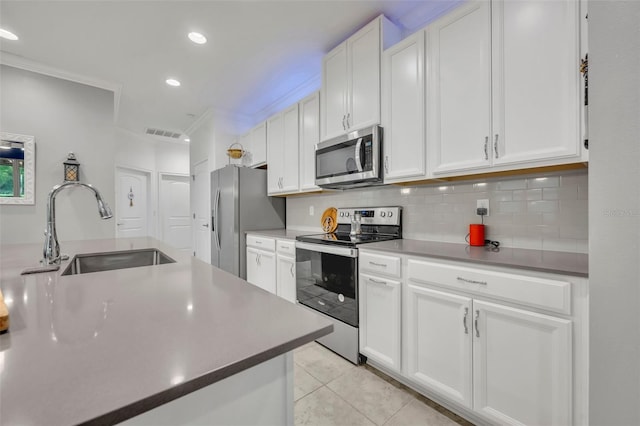 3149 Songbird Cir, Harmony, FL 34773 - kitchen with appliances with stainless steel finishes, a sink, white cabinetry, backsplash, and recessed lighting