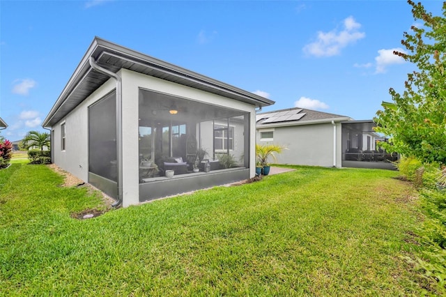 3149 Songbird Cir, Harmony, FL 34773 - rear view of property featuring a sunroom, a lawn, and stucco siding