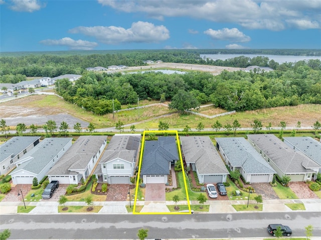 3149 Songbird Cir, Harmony, FL 34773 - aerial perspective of suburban area featuring property parcel outlined and a nearby body of water