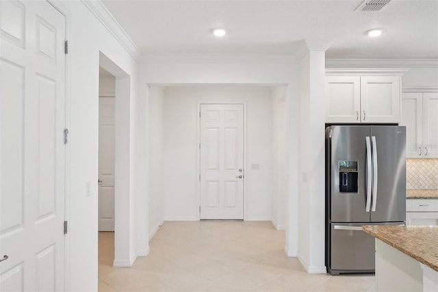 8932 SW 101st Cir, Ocala, FL 34481 - kitchen featuring stainless steel refrigerator with ice dispenser, light stone countertops, crown molding, white cabinetry, and baseboards