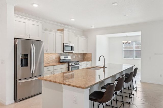 8932 SW 101st Cir, Ocala, FL 34481 - kitchen with appliances with stainless steel finishes, a sink, white cabinets, tasteful backsplash, and light tile patterned floors