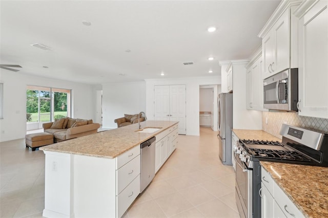 8932 SW 101st Cir, Ocala, FL 34481 - kitchen with appliances with stainless steel finishes, a sink, open floor plan, a center island with sink, and white cabinets