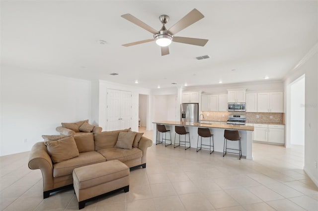 8932 SW 101st Cir, Ocala, FL 34481 - living room featuring a ceiling fan, light tile patterned floors, crown molding, and recessed lighting