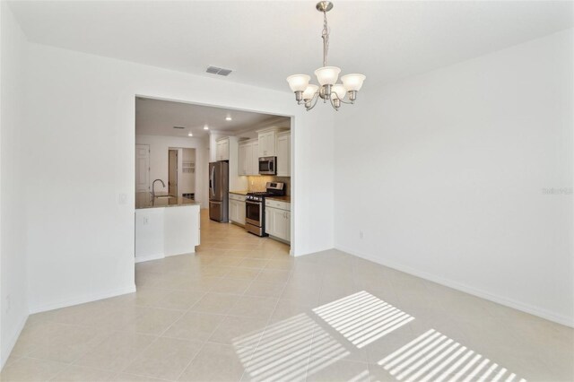 8932 SW 101st Cir, Ocala, FL 34481 - empty room featuring a chandelier, baseboards, light tile patterned flooring, a sink, and recessed lighting